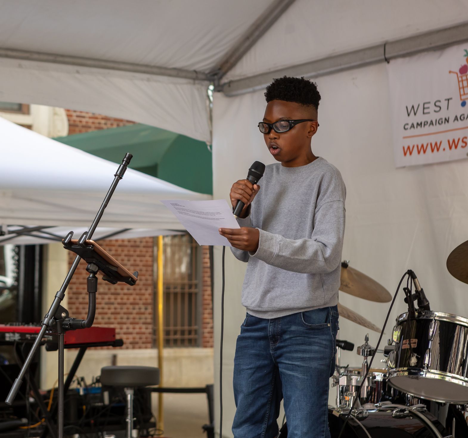 Student reading on the stage at ROCKS THE BLOCK