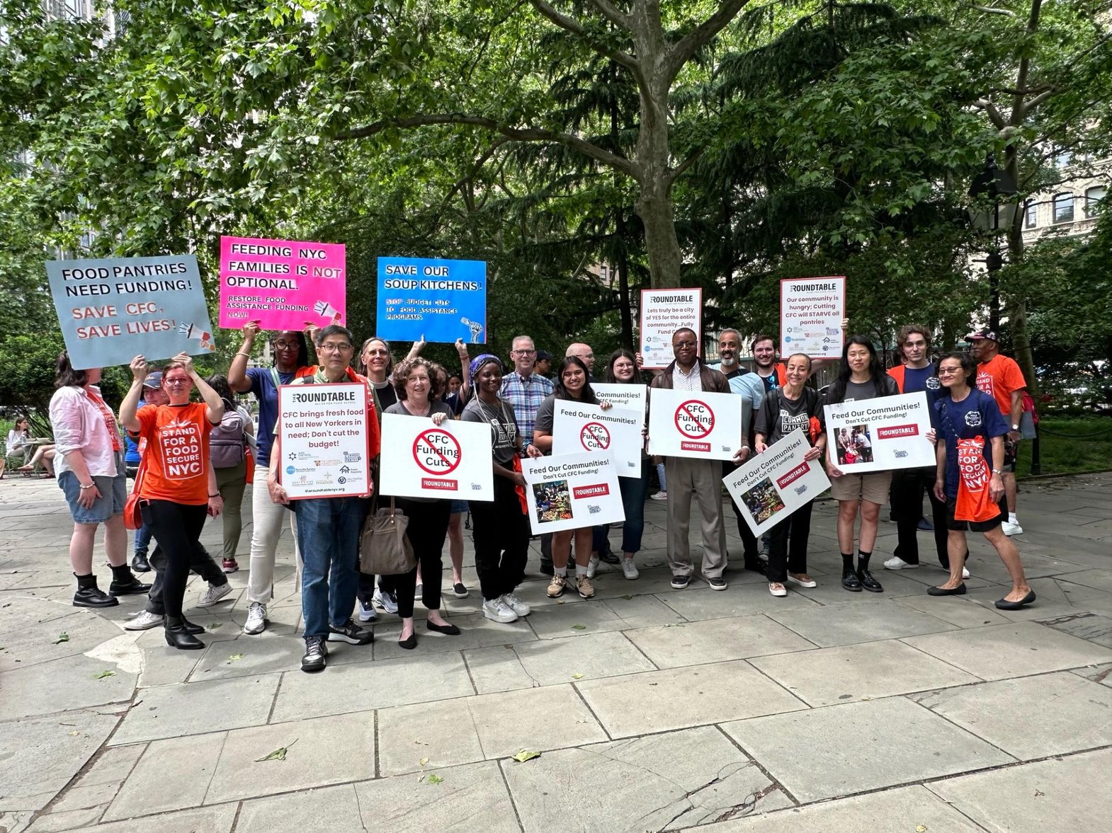 A crowd of people holding signs.