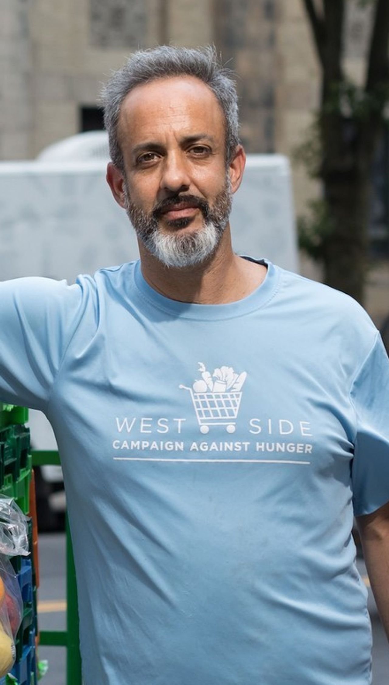Greg Silverman, WSCAH's CEO, stands outside in a WSCAH shirt on a sunny day