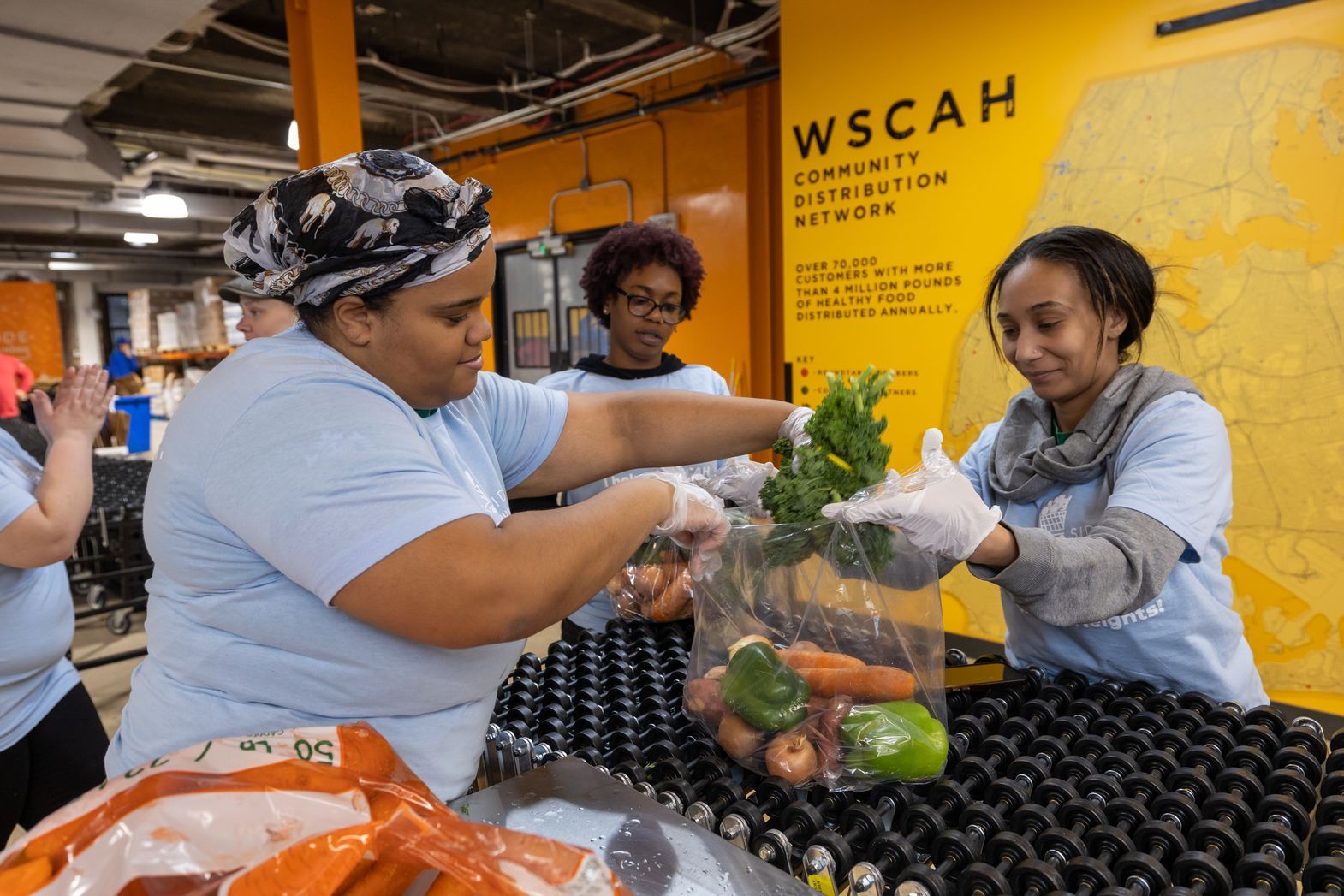 WSCAH volunteers packing food at 180th